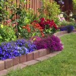 flower bed ideas here is a brick lined flowerbed against a fence in this yard. placing a  flower GZZQIQI
