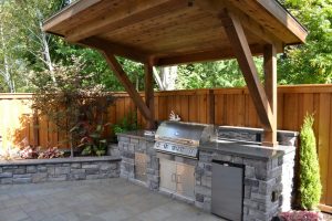 outdoor kitchen ideas rustic patio with polished concrete, outdoor kitchen, raised beds, stacked  stone, fence OSIYRYD