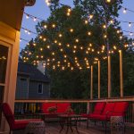 patio lights hanging across a backyard deck ZQBGMXL