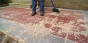 paver patio sweeping sand between pavers. EIQYQEE