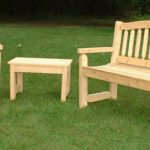 wooden garden furniture cypress bench, chair, and table on lawn GZOSJXZ