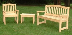 wooden garden furniture cypress bench, chair, and table on lawn GZOSJXZ