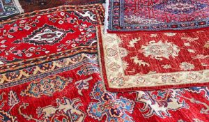 asian rugs for sale in the shop of fabrics and textiles - stock JEGSWTF