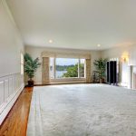 huge rug download large empty living room with fireplace and lake view. stock photo QVYQAOM