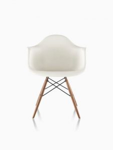 White Eames Molded Plastic armchair with dowel legs, viewed from the