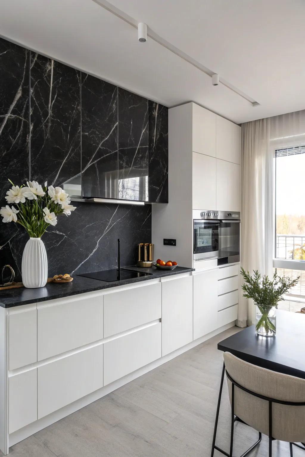 A kitchen featuring a black marble backsplash with subtle white veining and minimalist decor.