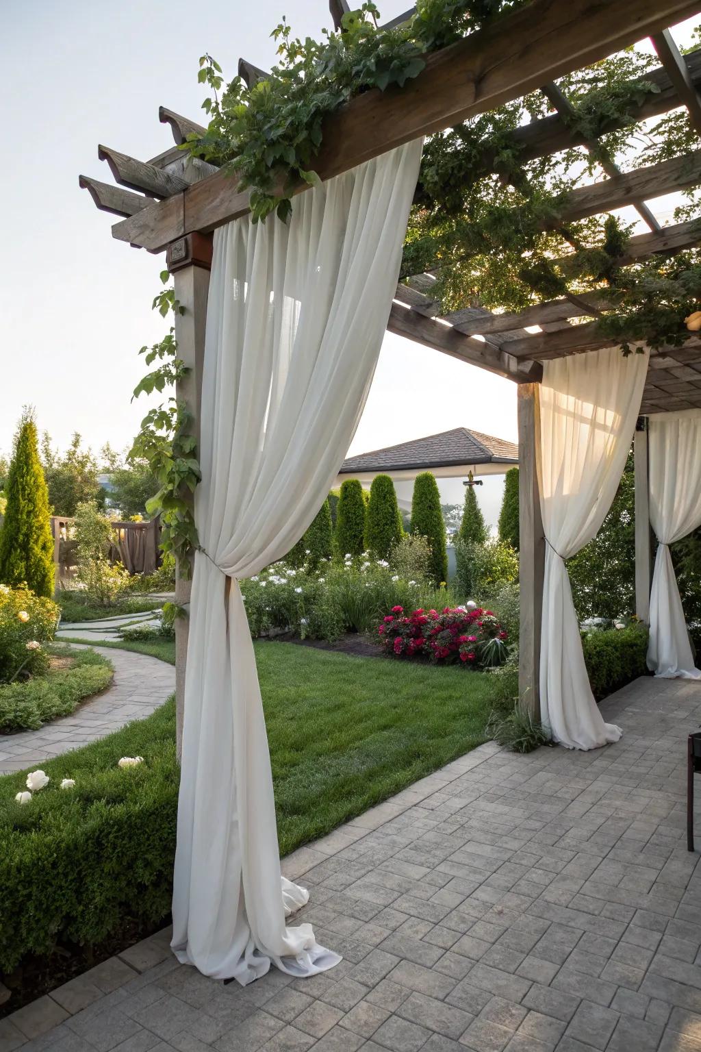 A pergola draped with curtains creating a private outdoor nook.