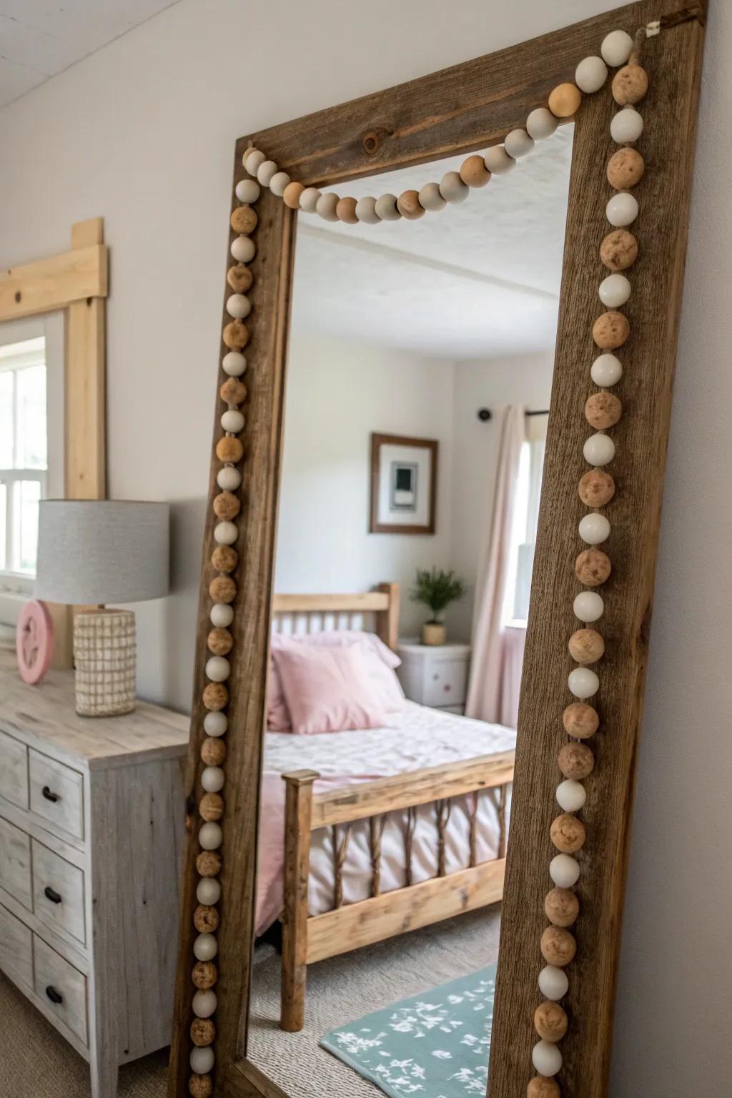 Mirror framed with a wooden bead garland for farmhouse style.