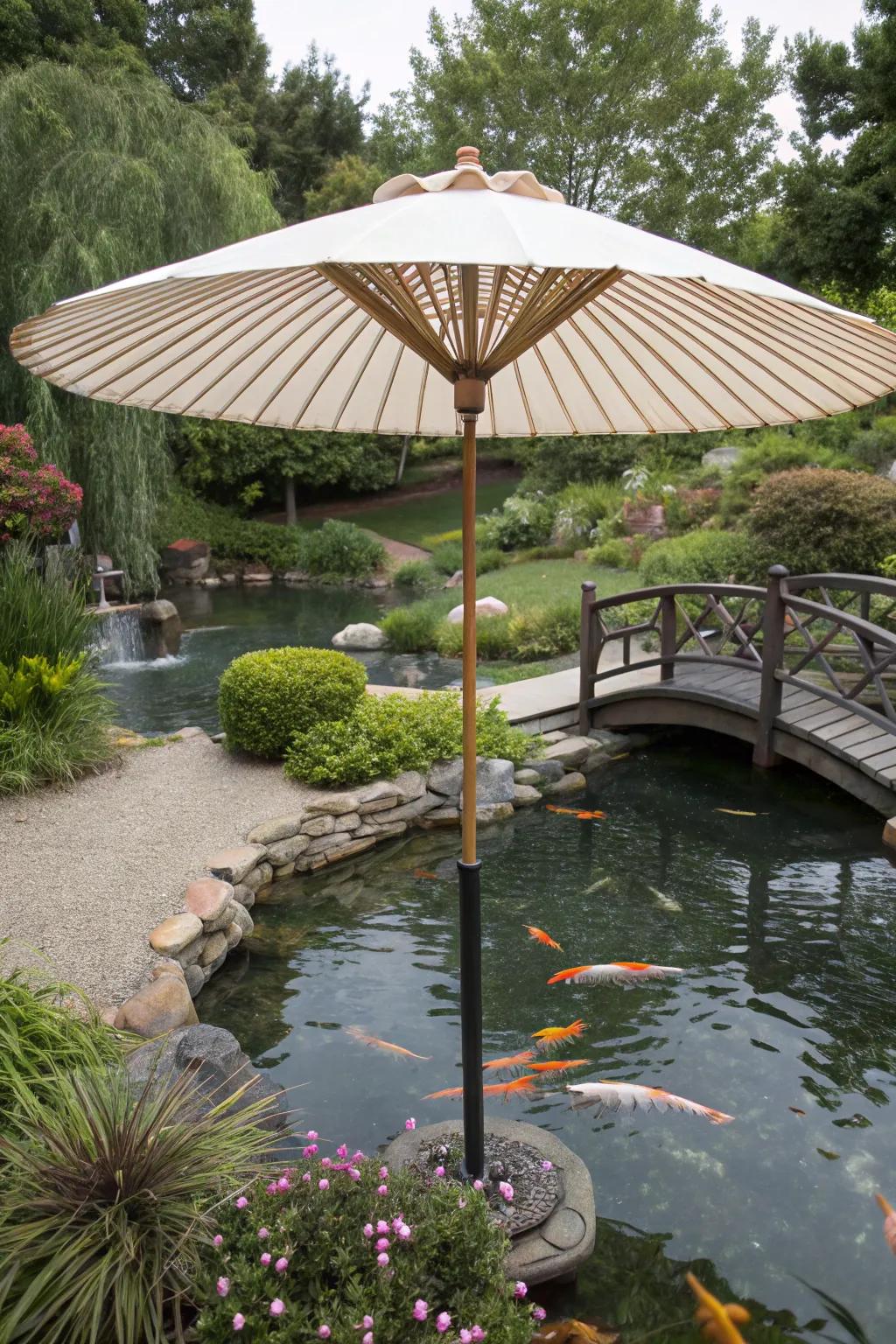 A koi pond shaded by a large garden umbrella.