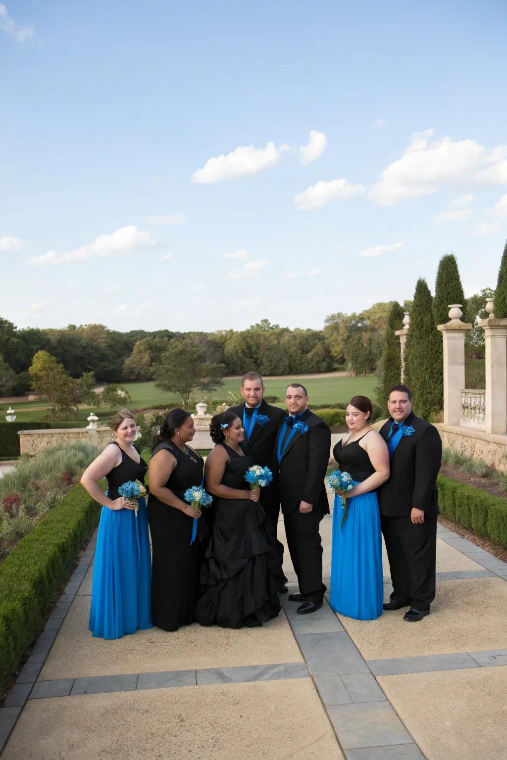 Bridal party dressed in coordinated black and blue outfits.